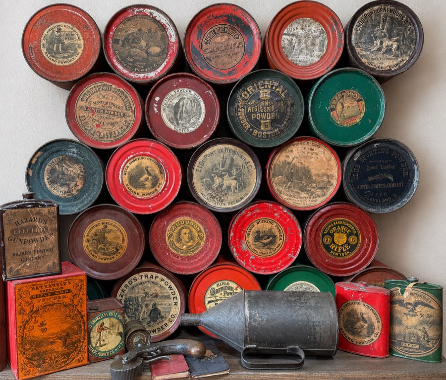 Antique gunpowder tins with aged paper labels